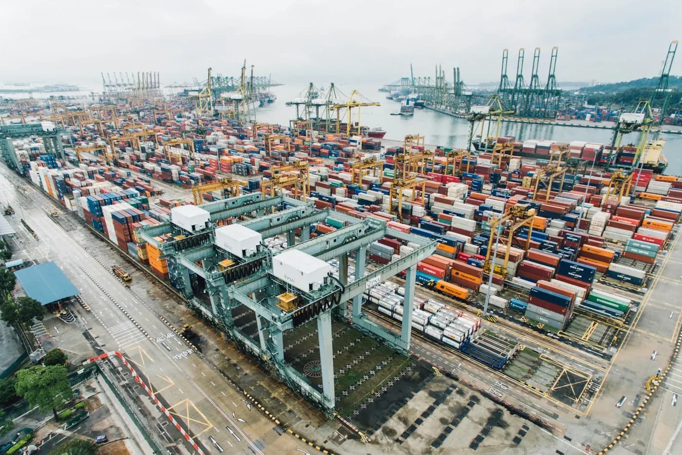 Container port with cranes and stacked shipping containers